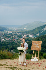 Portrait of a young couple after a marriage proposal in the mountains