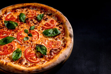 Delicious fragrant pizza with mozzarella, tomatoes and basil with tomato sauce - Margherita