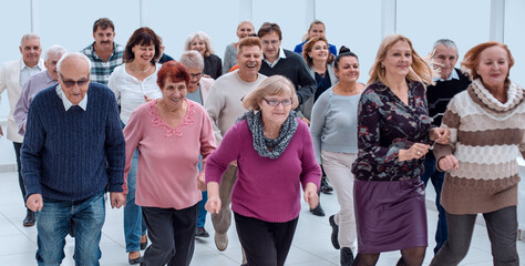 a group of pensioners are preparing to run forward