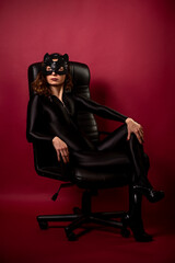 Obraz na płótnie Canvas Sexy young woman with black bodysuit and cat mask.