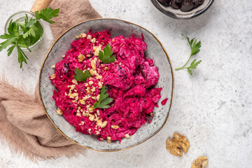Beetroot salad with prunes and garlic garnished with walnuts