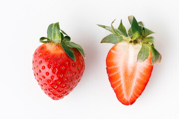 Top view of fresh red strawberries slice isolated on white background. Summer berries textured background. Flat lay. Macro shot of strawberry cut in a half