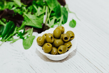 Mix of lettuce leaves different types with olives.
