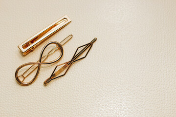 Gold ornaments from yellow metal on a light background.