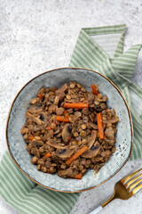 Lentil with mushroom, carrot and onion in bowl. Healthy lifestyle.