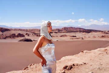 waist up art portrait latina woman with silver clothes and bandana or head cape in the desert of Valley of the Moon in the Atacama desert of San Pedro de Atacama