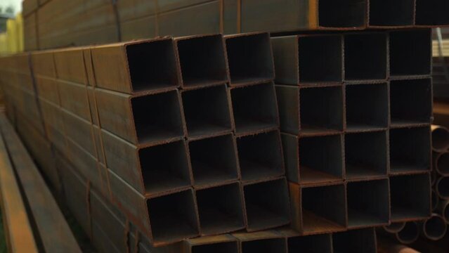 Square rusted metal pipes in a metal storage warehouse. Iron industry for construction.