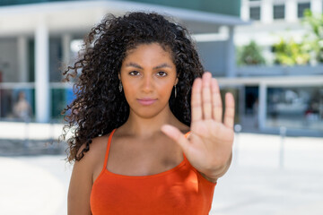 Latin american feminist woman gesturing stop