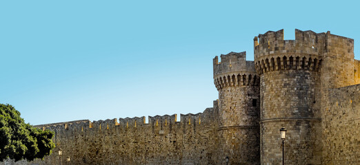 Medieval towers of the gate and defensive walls of the old citadel in Rhodes, Greece. Medieval fortress of crusaders of Maltese knights, panoramic landscape, design element of ancient architecture. - obrazy, fototapety, plakaty