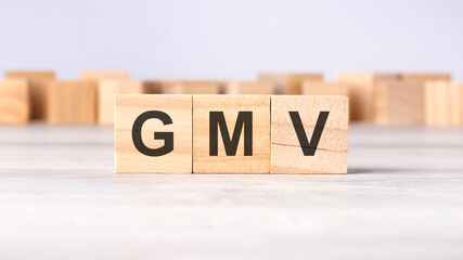 GMV - word concept written on wooden cubes or blocks on a light background