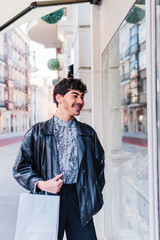 Smiling lgbt guy in stylish clothes, shopping in the city. integration concept.