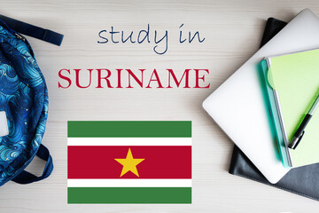 Study in Suriname. Background with notepad, laptop and backpack. Education concept.