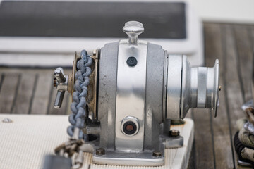 Anchor winch mounted on the bow of a boat.