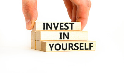 Invest in yourself symbol. Concept words Invest in yourself on wooden block on a beautiful white table white background. Businessman hand. Business and Invest in yourself concept. Copy space.