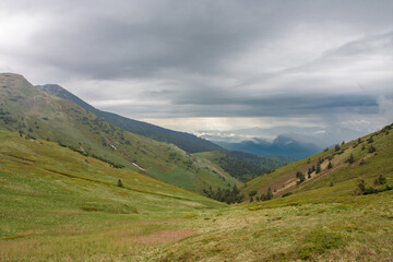 Fototapeta na wymiar Valley under Maly Krivan, view from mountain pass Bublen, national park Mala Fatra, Slovakia, spring cloudy day.