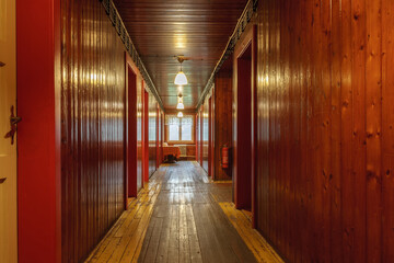 Corridor with wooden paneling inside a mountain cottage.