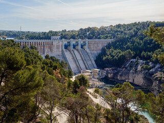 Gravity dam in Alarcon, in the course of Jucar river. Cuenca, Castilla La Mancha, Spain. The reservoir is called Embalse or Pantano de Alarcón in Spanish. Electricity generation, renewable energy