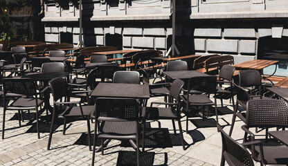 Empty restaurant summer terrace with tables and chairs. Reastaurant tables waiting for customers at an outdoor terrace.