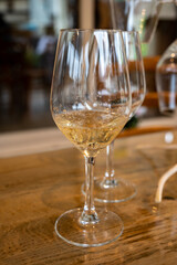 Tasting of cold brut Champagne sparkling wine in cellars of gran cru wine house in near Reims, wine tour in Champagne, France