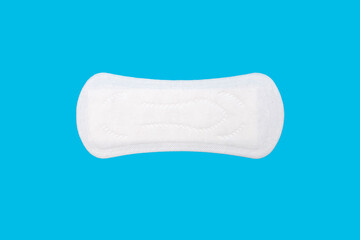 Feminine hygiene menstrual pad for the menstrual cycle on a blue background. Feminine hygiene product in the form of a sanitary napkin. A clean menstrual pad is positioned horizontally