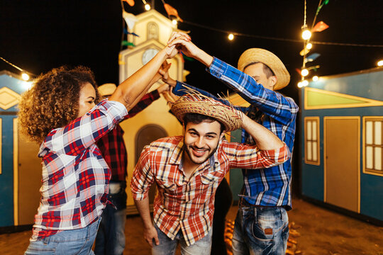Festa Junina in Brazil. Group of friends dancing the Brazilian square dance.