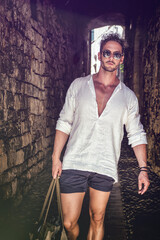Handsome man walking in ancient town's alley