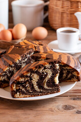 Homemade marble cake with a cup of coffee on wooden table