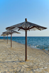 Row of beach umbrellas. Wreck parasols on the coast