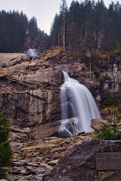 beautiful waterfall with rocks and trees