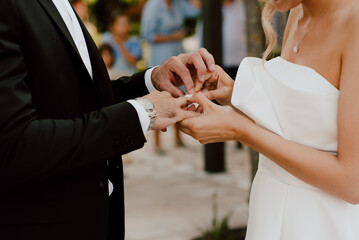 Obraz na płótnie Canvas Wedding rings hands bride and groom newlyweds day white decoration