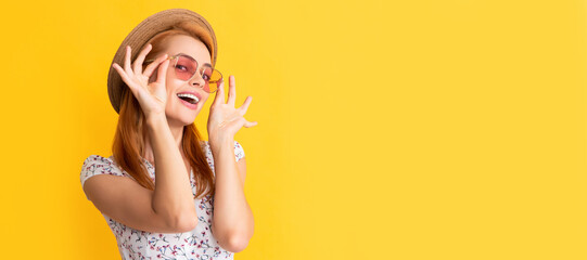 Woman isolated face portrait, banner with copy space background. glad young woman in straw hat and sunglasses on yellow background.