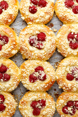Sweet yeast buns with the addition of raspberries, white chocolate and butter crumble, top view
