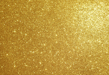 Golden shiny glitter background. Metallic glowing background.
