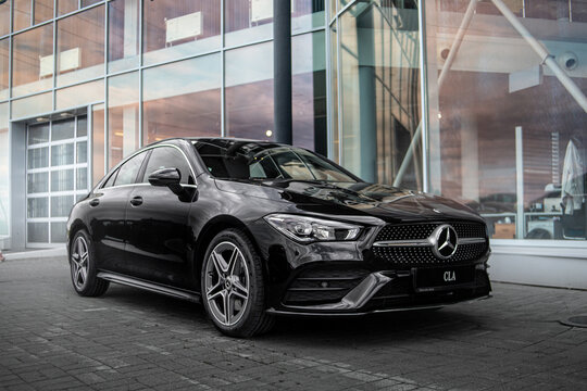 car in the street black Mercedes CLA front
