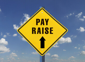 Yellow warning sign against the sky