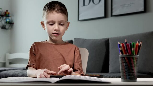 Little boy Counting with help an abacus. Mental arithmetic, brain development.