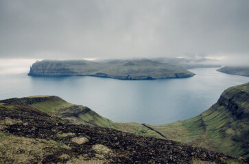 View from the Sornfelli mountain in Faroe Islands to the famous Trollkonufingur, witchs finger on Vagar island, Denmark, Northern Europe