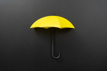 Yellow umbrella isolated on black background