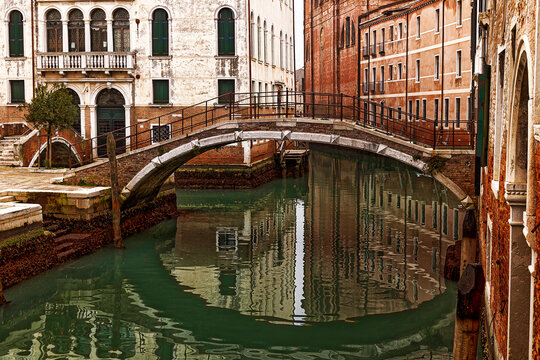 one canal with a round bridge in Venice, Italy