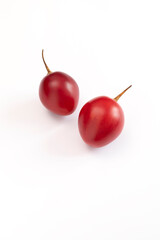 Isolated Fresh Tamarillo Fruit On White Background. Egg-shaped Edible Fruit Known As Tree Tomato, Plant Family Solanaceae, Solanum Betaceum. Top View. Flat Lay. Vertical Plane