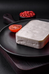 Delicious fresh rectangular shaped feta cheese with spices and vegetables