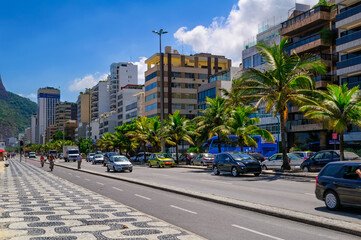 Obraz premium Ipanema with mosaic of sidewalk in Rio de Janeiro, Brazil. Ipanema beach is the most famous beach of Rio de Janeiro, Brazil. Cityscape of Rio de Janeiro.