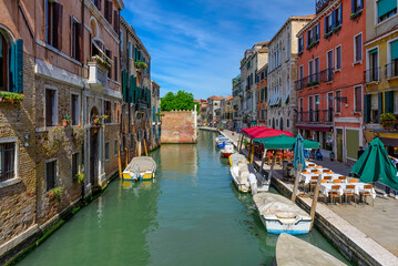 Narrow canal with bridge in Venice, Italy. Architecture and landmark of Venice. Cozy cityscape of Venice.