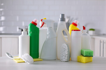 A set of different cleaning and disinfection products against the background of the home interior 