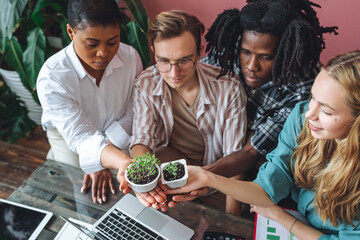 International group of diverse multiracial students working on the biological project, creating new species of plants and flowers. Ecological environmental university college study, experiment, test