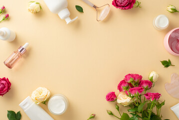 Tender skin care routine concept. Top view of cream jars, jade roller, and rose flowers on a pastel beige background with an empty space for branding or advert