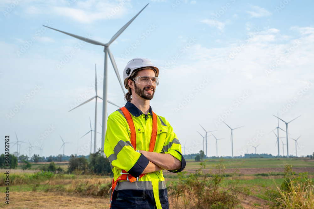 Poster engineer inspection and survey work in wind turbine farms rotation to generate electricity energy.