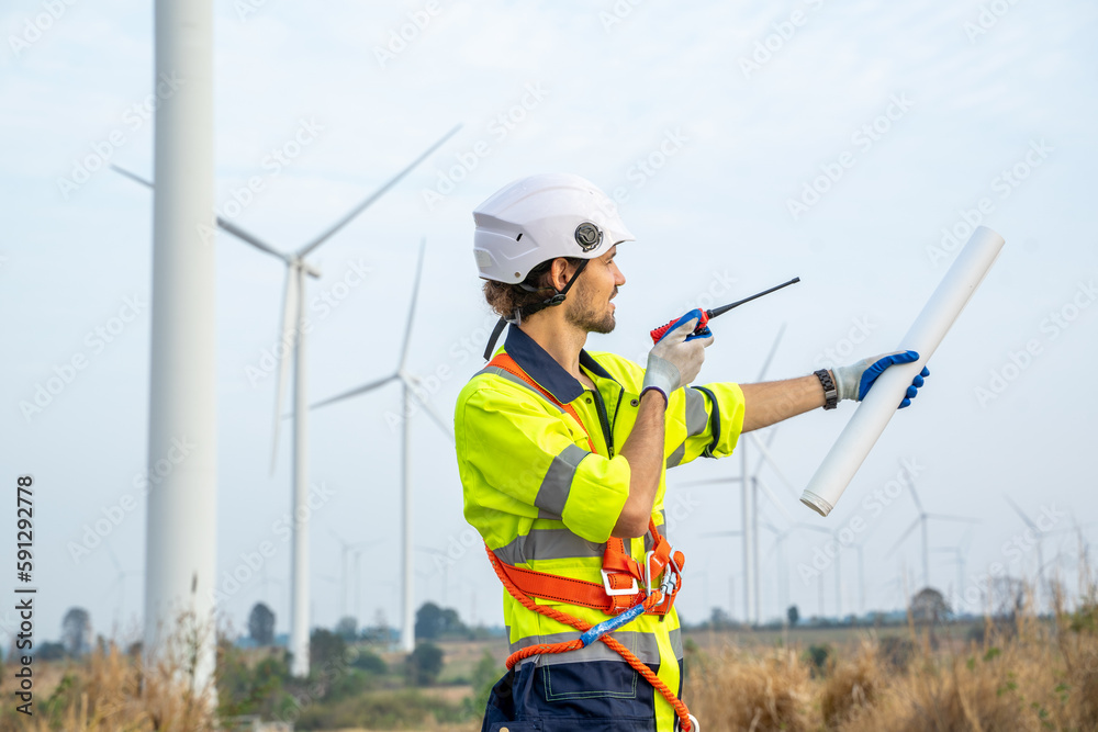 Poster engineer working at renewable energy farm,inspector controlling functioning of wind turbines outdoor