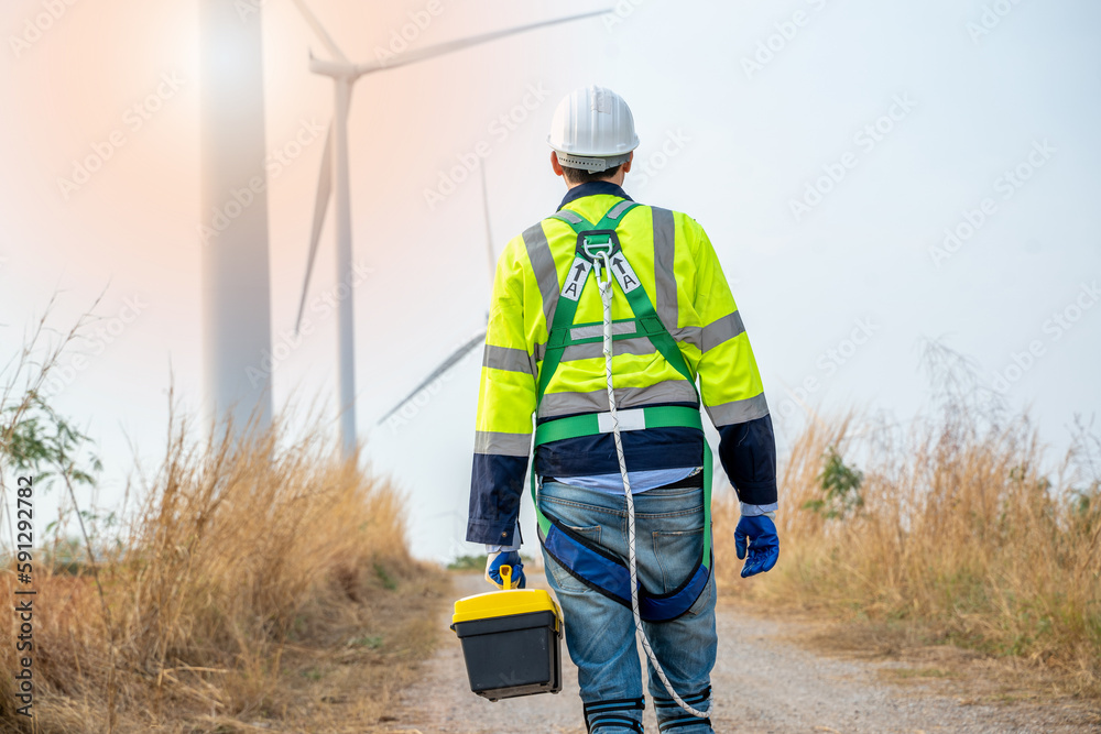 Poster electrical engineer checking on wind turbine energy production,concept of alternative energy and ser