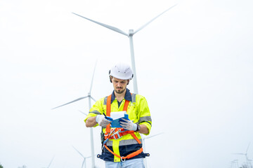 Fototapeta na wymiar Maintenance engineer man working in wind turbine farm,Wind turbine operations that transform wind energy into electrical electricity,Clean energy concept saves the world.